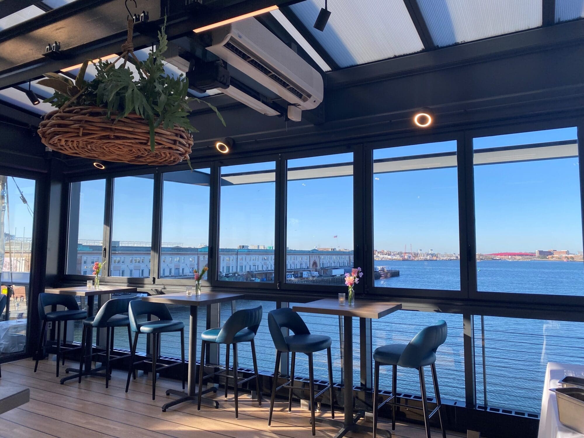a view from the rooftop bar overlooking the ocean on a sunny day