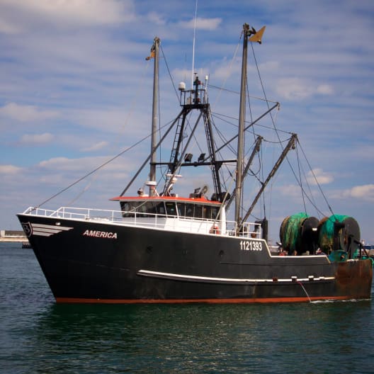 A black fishing vessel named