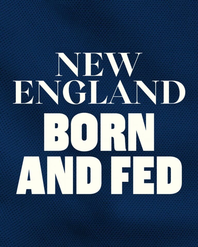 Text on a dark blue textured background reads: “New England Born and Fed” in large white capital letters.